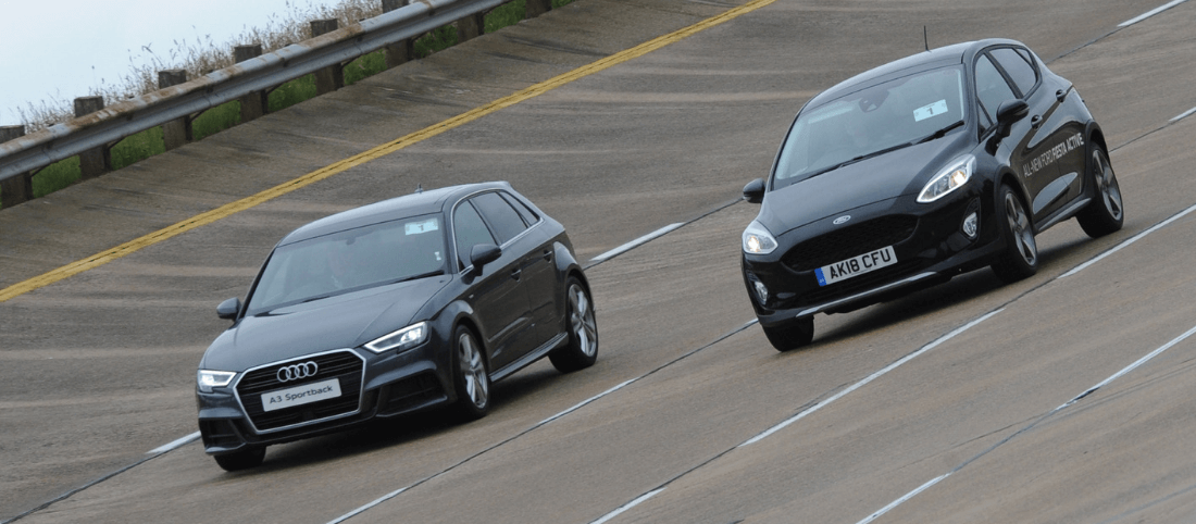 Audi A3 Sportback and Ford Fiesta driving on high speed bowl